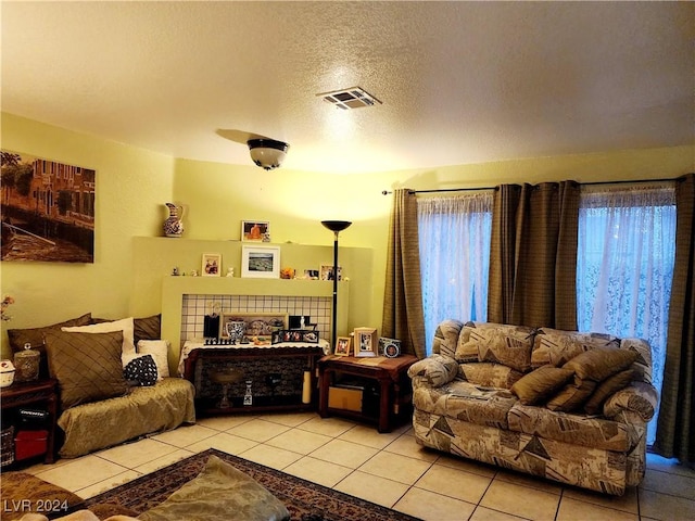 living room with light tile patterned floors, a textured ceiling, and a wealth of natural light