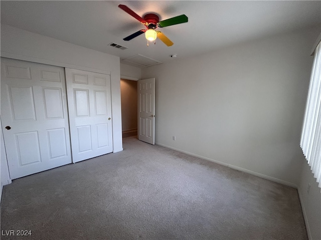 unfurnished bedroom with carpet floors, a closet, and ceiling fan