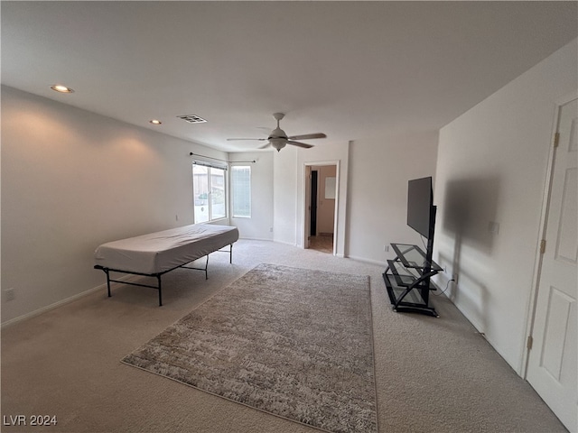 unfurnished bedroom featuring ceiling fan and light colored carpet