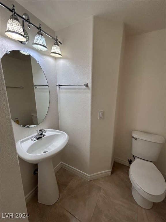 bathroom with tile patterned flooring and toilet