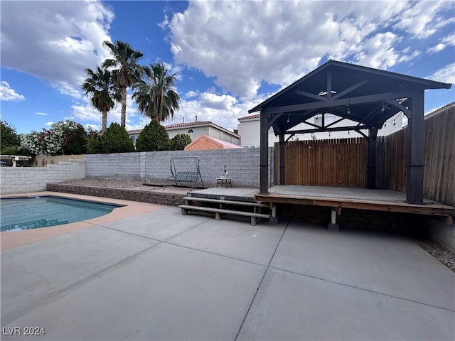 view of pool featuring a patio and a deck