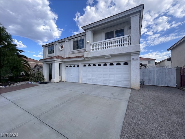 view of front property featuring a balcony and a garage