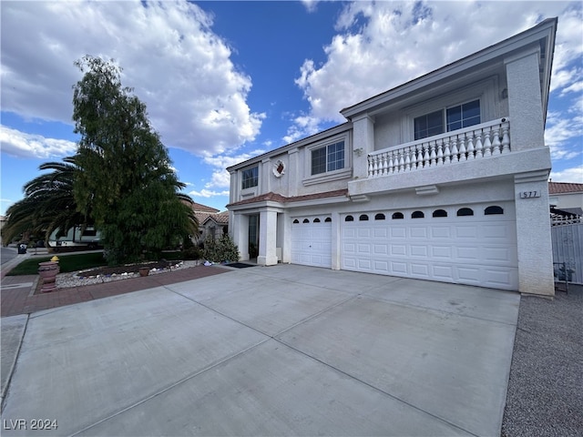 front of property with a balcony and a garage