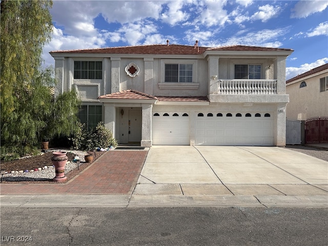 view of front of home featuring a balcony and a garage