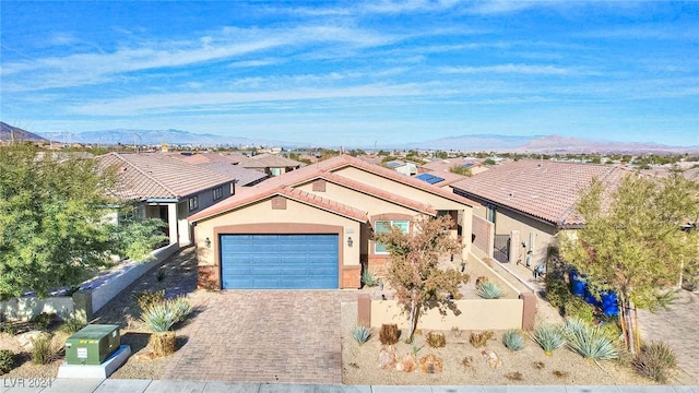 view of front facade featuring a mountain view and a garage