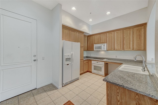 kitchen with white appliances, sink, and light tile patterned floors