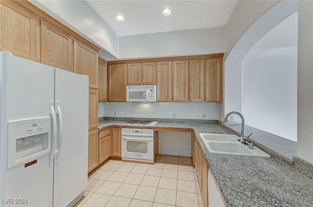 kitchen with light brown cabinetry, sink, light tile patterned flooring, and white appliances