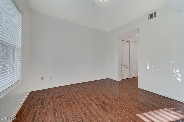 unfurnished room with dark hardwood / wood-style floors