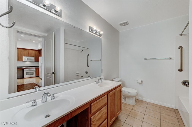 bathroom with tile patterned flooring, vanity, and toilet