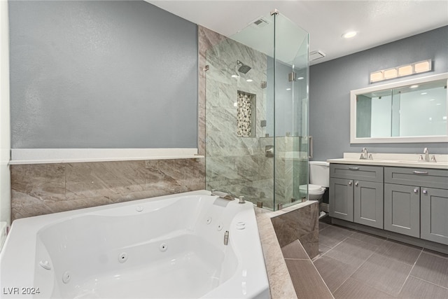 full bathroom featuring tile patterned flooring, shower with separate bathtub, vanity, and toilet