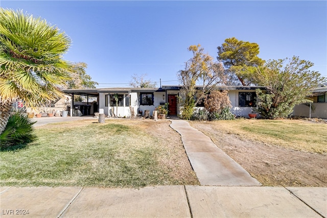 ranch-style house with a front lawn and a carport