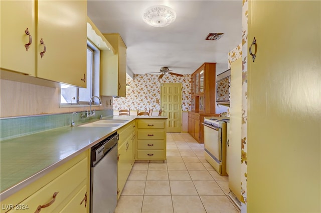 kitchen featuring dishwasher, sink, ceiling fan, light tile patterned floors, and white range oven