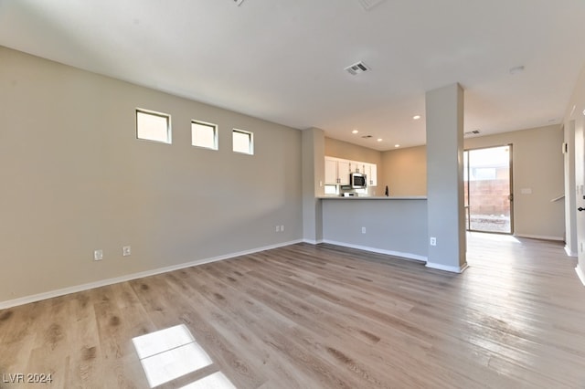 unfurnished living room featuring light hardwood / wood-style flooring