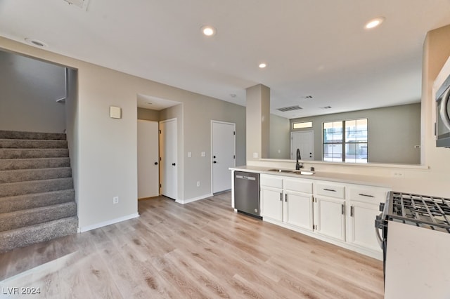 kitchen with white cabinetry, light wood-type flooring, sink, and appliances with stainless steel finishes