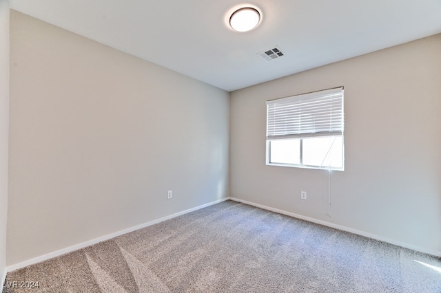 unfurnished room featuring carpet