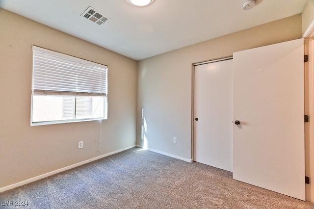 unfurnished bedroom featuring light carpet