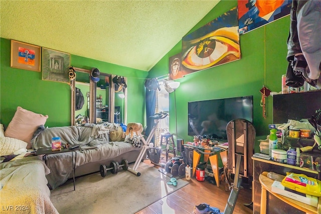 playroom with hardwood / wood-style flooring, vaulted ceiling, and a textured ceiling