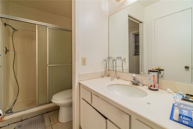 bathroom featuring vanity, an enclosed shower, tile patterned floors, and toilet