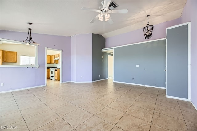 tiled spare room with ceiling fan with notable chandelier and vaulted ceiling