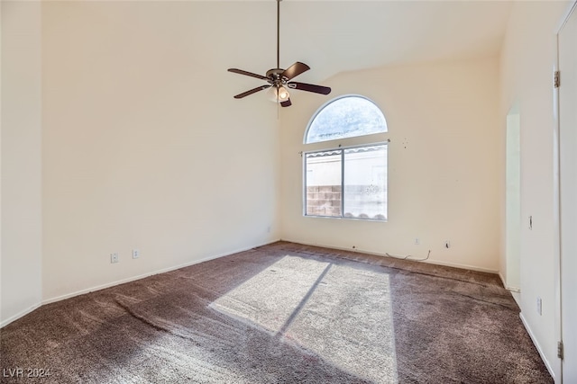 empty room featuring carpet flooring, ceiling fan, and high vaulted ceiling