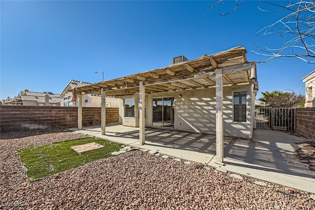 back of property with a pergola and a patio