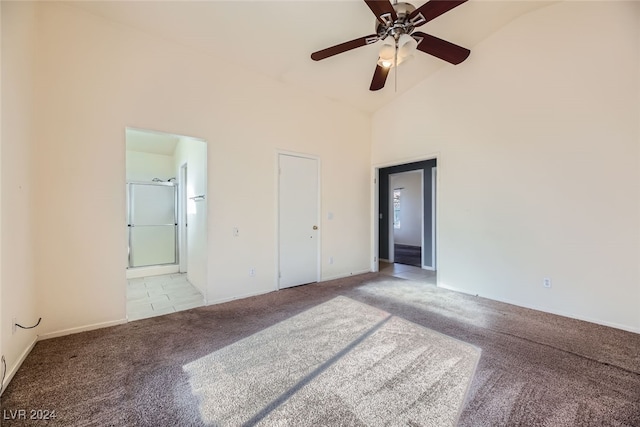 unfurnished bedroom with light colored carpet, high vaulted ceiling, ensuite bath, and ceiling fan