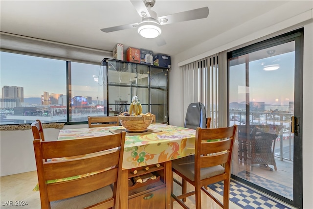 dining space with light tile patterned flooring, plenty of natural light, and ceiling fan