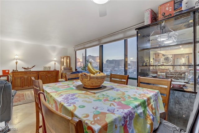 dining space with light tile patterned floors and floor to ceiling windows