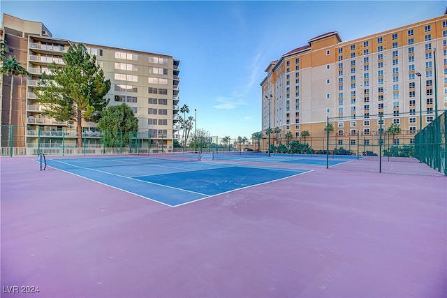 view of tennis court with basketball hoop