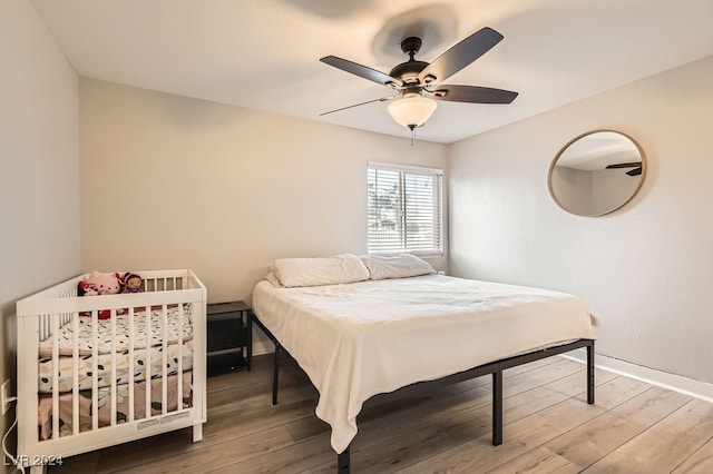 bedroom with ceiling fan and wood-type flooring