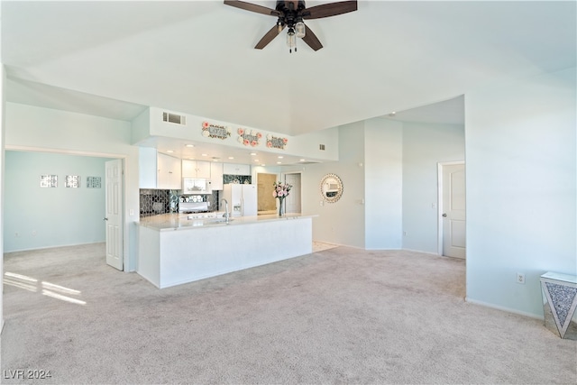 kitchen with white cabinets, white appliances, tasteful backsplash, and light colored carpet