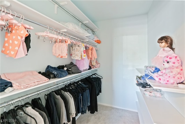 spacious closet featuring light colored carpet