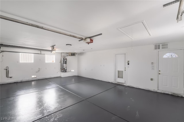 garage featuring gas water heater and a garage door opener