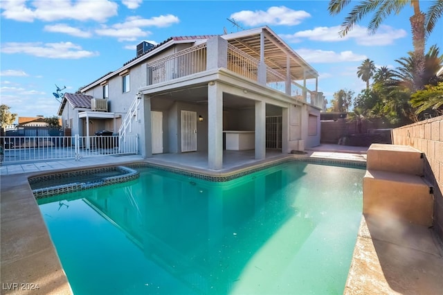 view of pool with an in ground hot tub and a patio