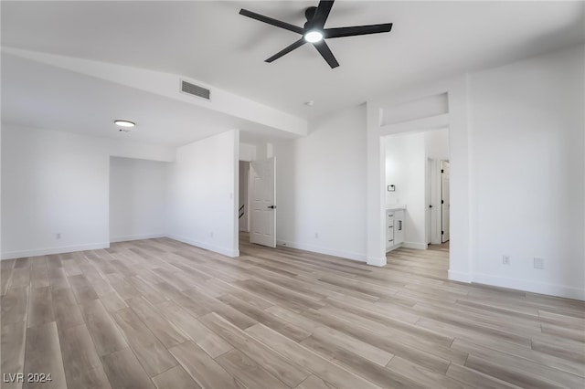 spare room with light wood-type flooring and ceiling fan