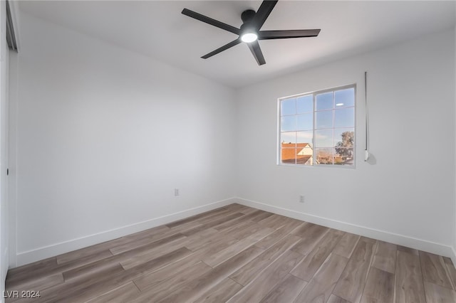 spare room with light wood-type flooring and ceiling fan