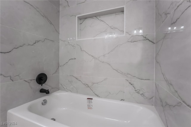 bathroom with a tub to relax in