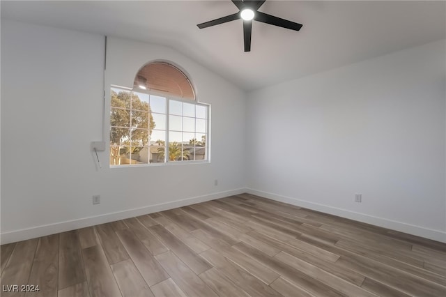 unfurnished room with hardwood / wood-style floors, ceiling fan, and lofted ceiling