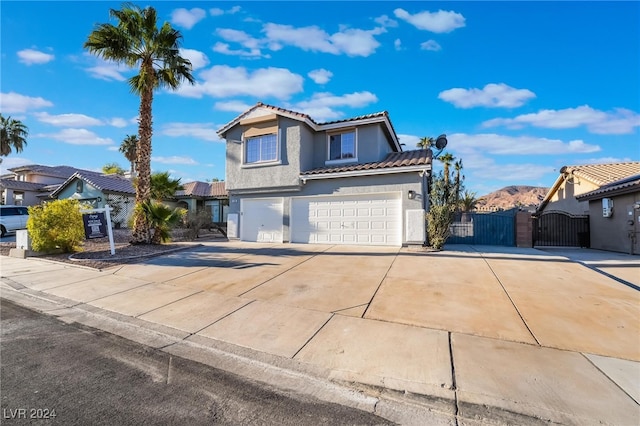 front facade with a mountain view and a garage