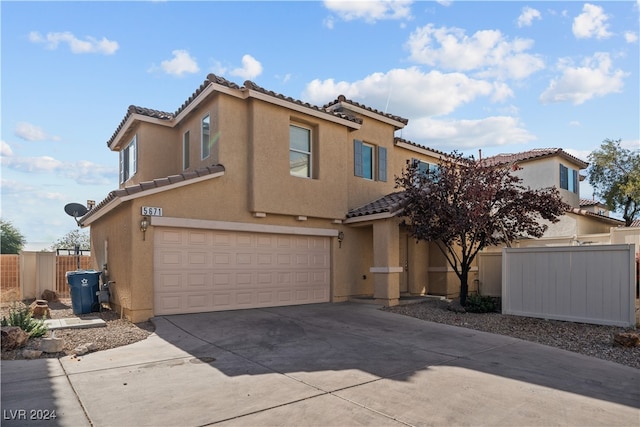 mediterranean / spanish-style home with a garage