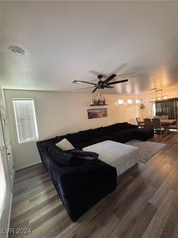 living room with dark hardwood / wood-style flooring and ceiling fan