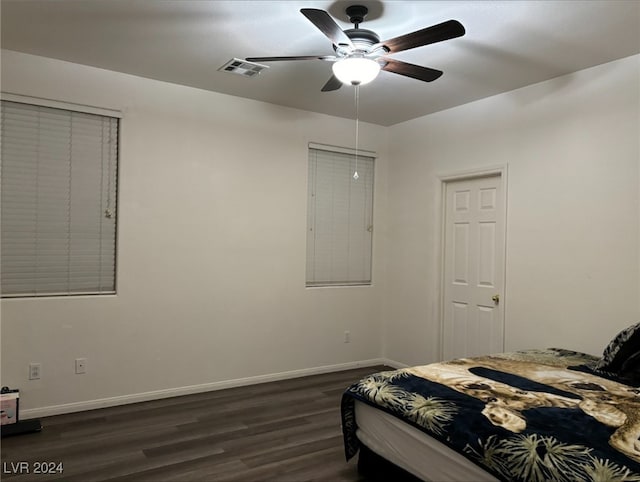 bedroom featuring ceiling fan and dark hardwood / wood-style floors