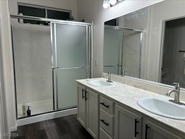 bathroom featuring wood-type flooring, vanity, and walk in shower