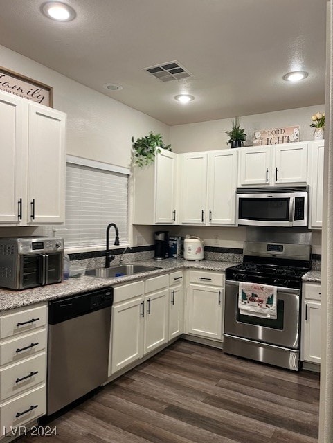 kitchen with white cabinetry, stainless steel appliances, and sink