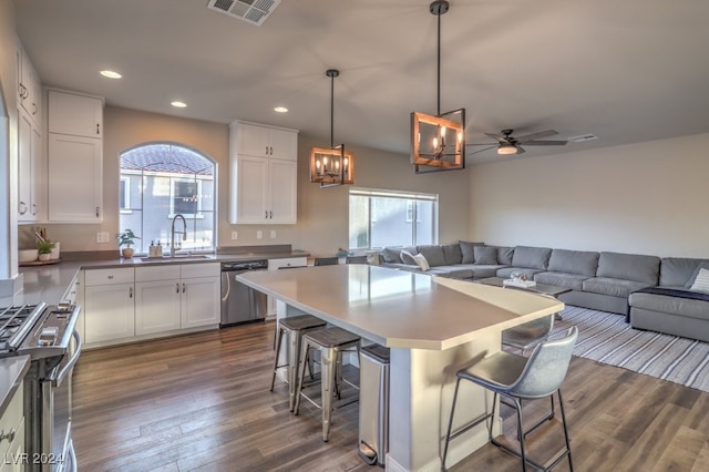 kitchen featuring sink, white cabinetry, stainless steel appliances, and a wealth of natural light