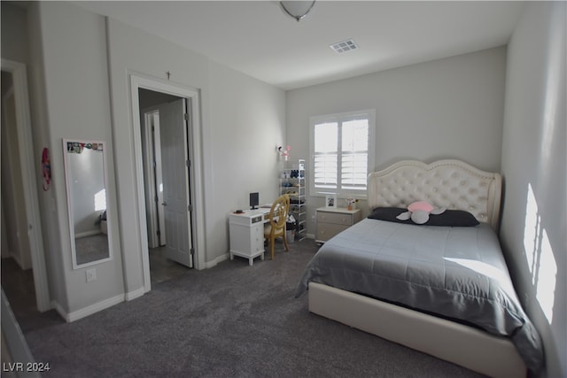 bedroom featuring dark carpet