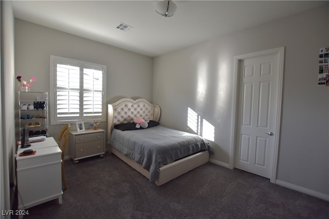 bedroom with dark carpet