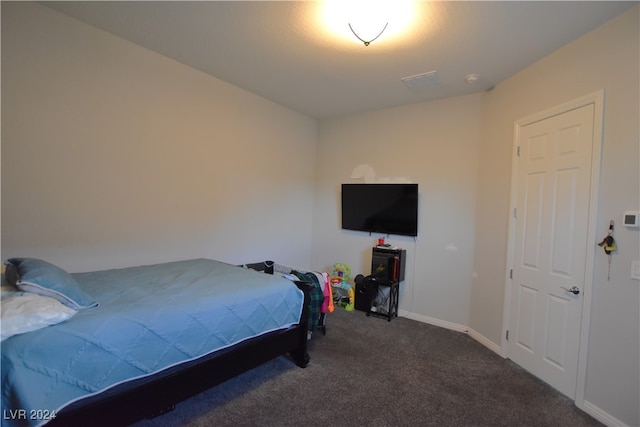 bedroom with dark colored carpet