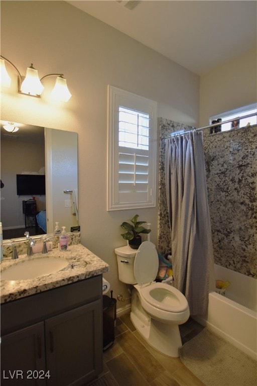 full bathroom with vanity, shower / bath combo, and toilet