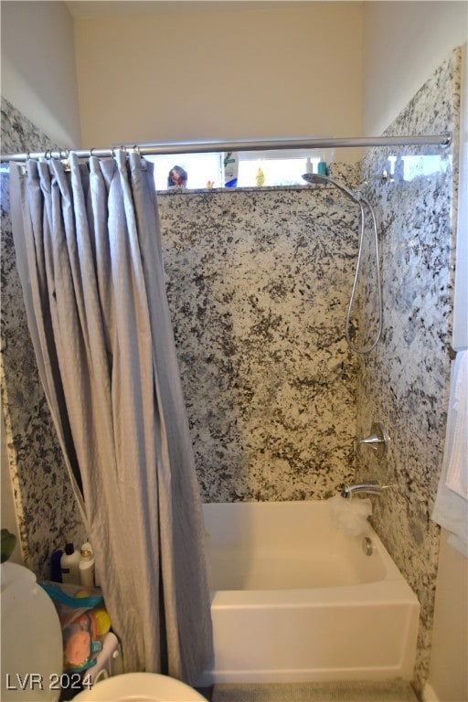 bathroom featuring shower / tub combo with curtain and toilet